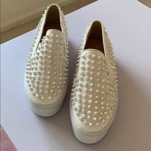 White slip ons snickers with spikes